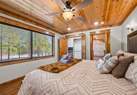 Another view of this bedroom with king bed offers a comfy place to rest after a long day of hiking, gaming, or simply relaxing.