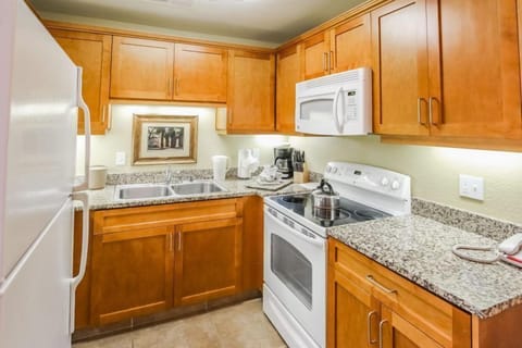 The fully equipped kitchen boasts modern appliances and ample counter space for meal preparation, enhancing the appeal of your spacious condo in the heart of the desert getaway.