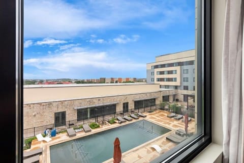 Soak up sunshine with a serene pool view below.