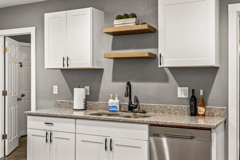 A kitchen that speaks in clean lines, subtle shine, and total functionality.