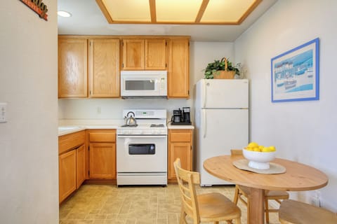The fully equipped kitchen has a refrigerator, stove and oven, microwave, k-cup coffee maker, and dish ware—everything you need to whip up meals or enjoy a fresh cup of coffee before heading to the beach.