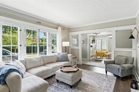 Living room on Main floor. Sectional sofa, arm chair and tv.