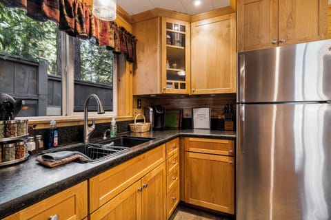 View the pines in the nicely stocked kitchen.