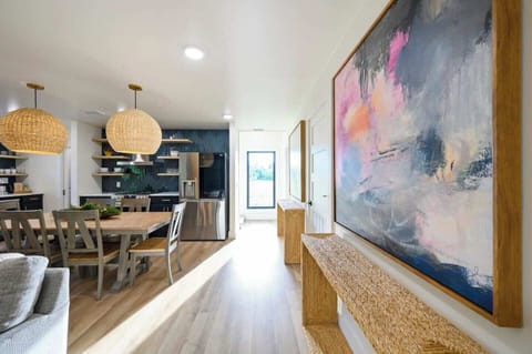 Enjoy the beautiful artwork and the stunning window view of the backyard, where nature provides a peaceful and picturesque backdrop.