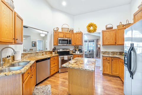 Fully equipped kitchen featuring a flat-top electric range and 2-door refrigerator