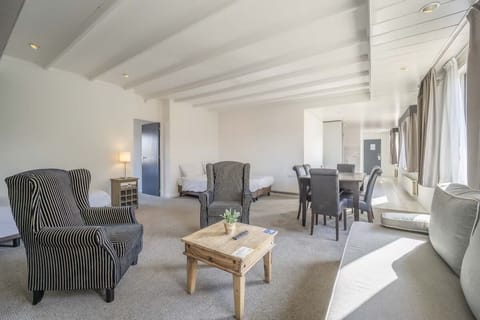 Living area. Exact unit will be assigned upon arrival. Views, colors, and decor may vary.