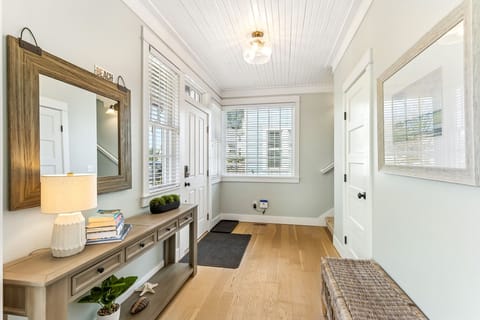 Bright entryway connecting main floor living room and stairs to second level