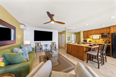 With a cozy green sofa, modern kitchen, and a perfect spot for morning coffee