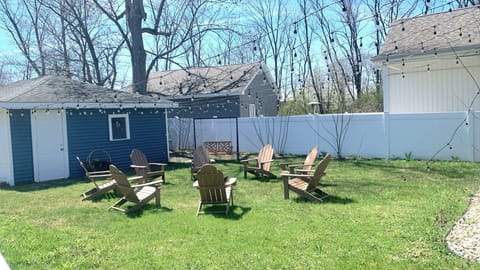 Backyard with adirondack chairs and grassy lawn