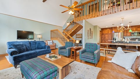 Spacious living room with cozy seating and a perfect view of the kitchen!