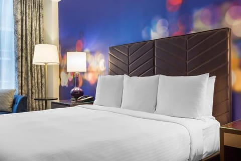 Drift off fast with cozy pillows and warm bedside glow.
