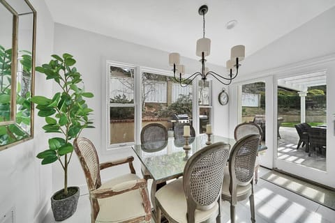 Dining with seating for six and view of backyard
