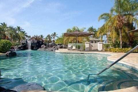 Cool off in this lagoon style pool surrounded by swaying palms and a serene rock waterfall.