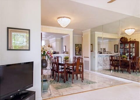 Elegant dining area flows into a well-lit living space, perfect for family dinners.