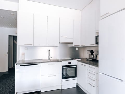 The apartment`s kitchen is well-equipped and includes an oven, full-size fridge-freezer, stove, and dishwasher.