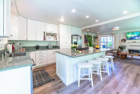 The kitchen features modern appliances, plenty of - counter space, and a full suite of cookware and utensils.