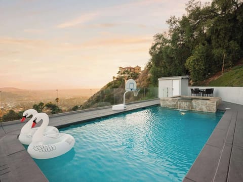 Pool with swan floatees and jacuzzi 