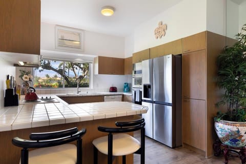 Whip up tropical meals in this spacious kitchen with stainless steel appliances and beautiful views.