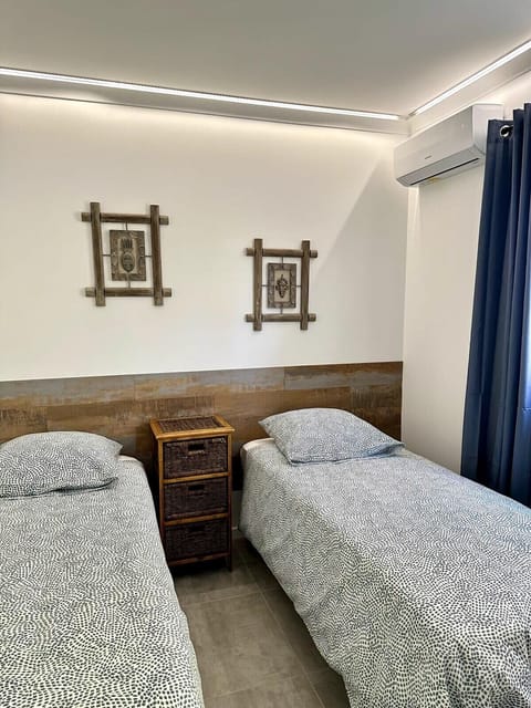 first bedroom with two simple bed