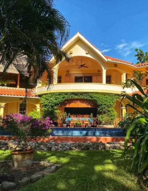 Villa Exterior with Pool & Balcony
Elegant two-story villa with balcony overlooking the pool and gardens.