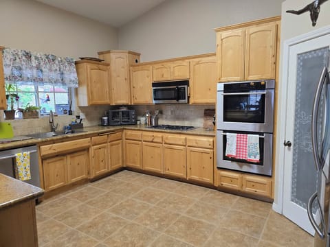 Double ovens, microwave, air fryer, toaster, fridge and dishwasher.