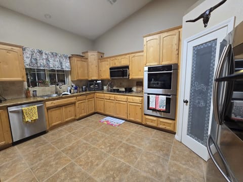 Large kitchen with upgraded appliances and pantry.