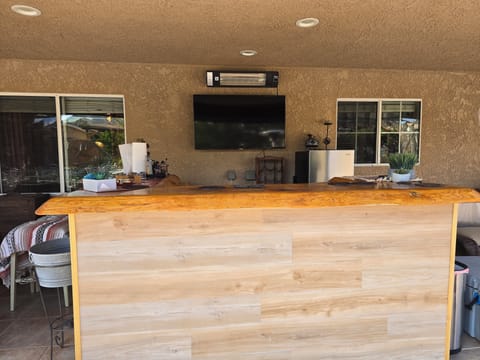 Outdoor bar, fridge, and smart TV.
