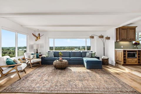 Sun soaked living room with a big screen tv