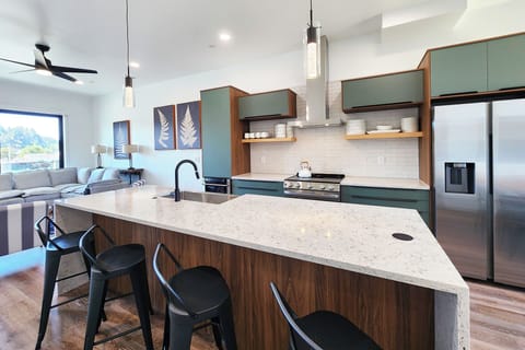 Kitchen island is a perfect spot to sit and enjoy morning coffee.