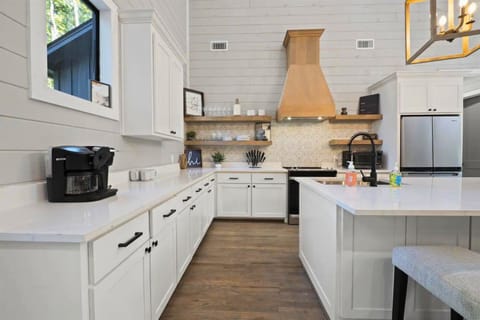 Start your day in this beautifully designed kitchen, where modern charm meets functionality and coffee is always just a step away.