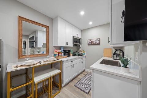 Sleek style meets convenience in this fully equipped kitchenette.