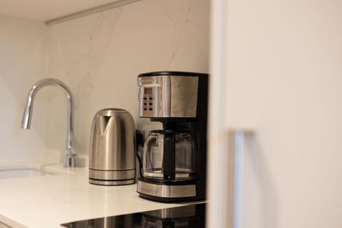 Coffee maker and electric kettle in a sleek kitchenette – start your seaside mornings with a fresh cup of coffee.