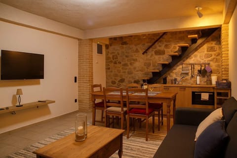 Spacious Living Room with Stone Walls – Cozy ambiance blending tradition and comfort.