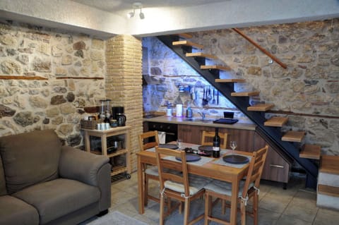 Cozy Living and Dining Area with Stone Walls – Warm and intimate space featuring traditional stonework and wooden details.
