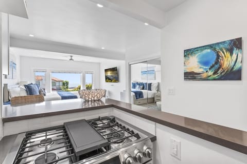 Compact kitchen with modern white cabinetry and essentials.