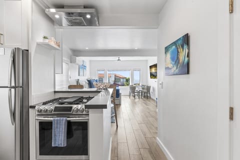Sleek, fully equipped kitchen leading to the open-concept living space.