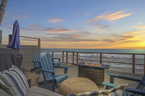 Breathtaking sunset views from the oceanfront deck with a cozy fire pit.