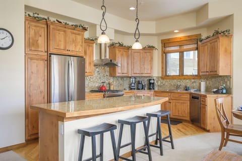 - Kitchen island with seating for three adds space for dining and conversation - Granite countertops and pendant lighting highlight this warm rustic design - Fully equipped kitchen blends style function and comfort for group meals