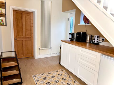 A kitchenette area , with toaster, microwave, air fryer, hot plate , kettle.