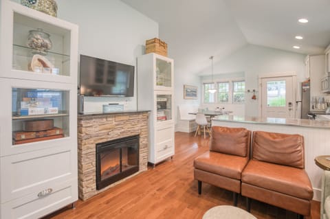 The living room with books, games, a fireplace, and TV. 