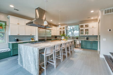 Modern chef's kitchen featuring a large double-door refrigerator. (Main house)