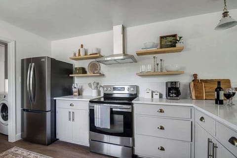 The floating shelves add a modern touch to the kitchen while providing practical storage space.