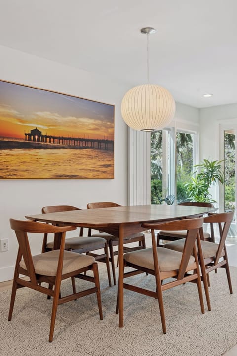 Comfortably sits 6 guests with additional seating at the kitchen counter