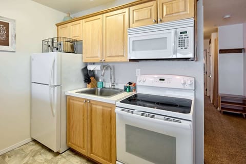 The kitchen has a full-size stove/oven and fridge