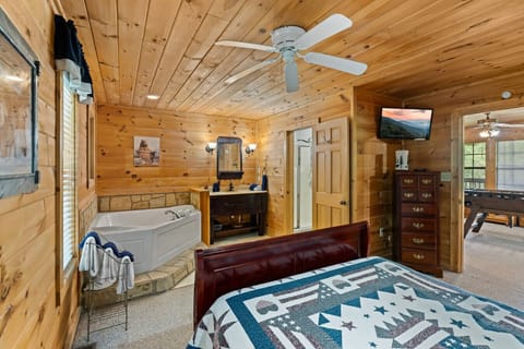 Unwind in a private retreat where your bedroom flows into a soaking tub and ensuite bathroom—just steps away from a cozy bed and evening TV time.