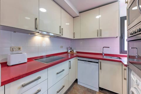 Fully equipped kitchen with appliances and storage space. (1)