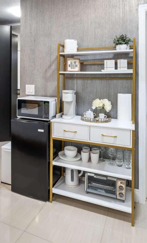 Kitchenette equipped with all essentials. Mini-fridge, microwave, coffee maker, tea-kettle, all-in-one toaster oven & airfryer. Dining essentials, plates, bowls & silverware.