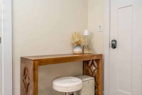 A small esthetic space with a comfortable feel, a wooden table with a small lamp and chair for your workplace or study.