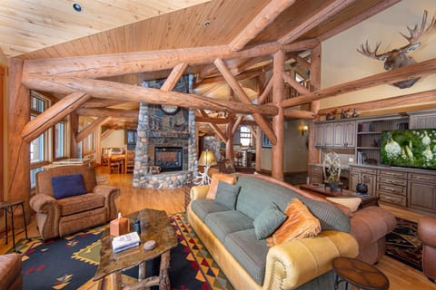 The pass-through fireplace connects the living room, dining room & kitchen | Main Level