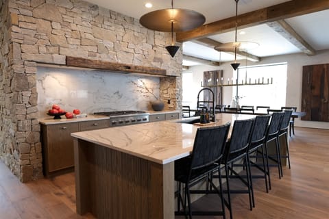 The kitchen offers access to the home's patio, dining area, and living room | Main Level